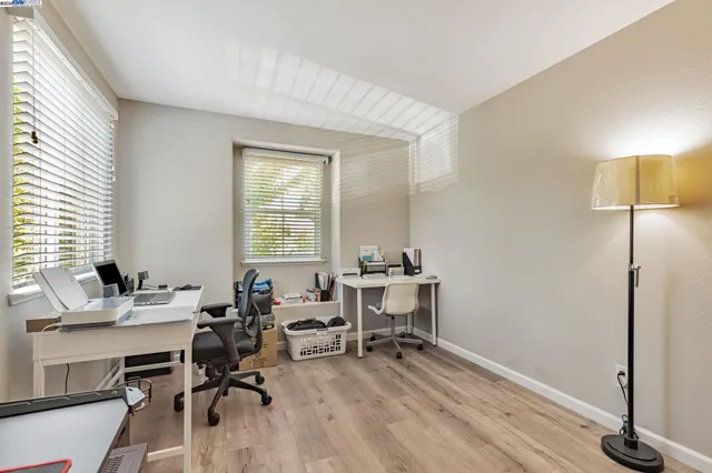 a view of a workspace with furniture and a window