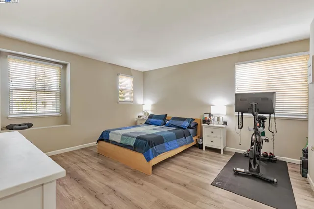 a spacious bedroom with a bed and a large window