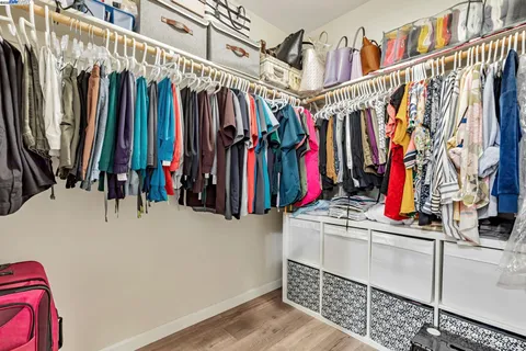 a view of walk in closet with clothes