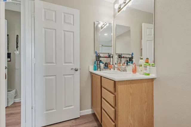 a bathroom with a sink vanity and a mirror