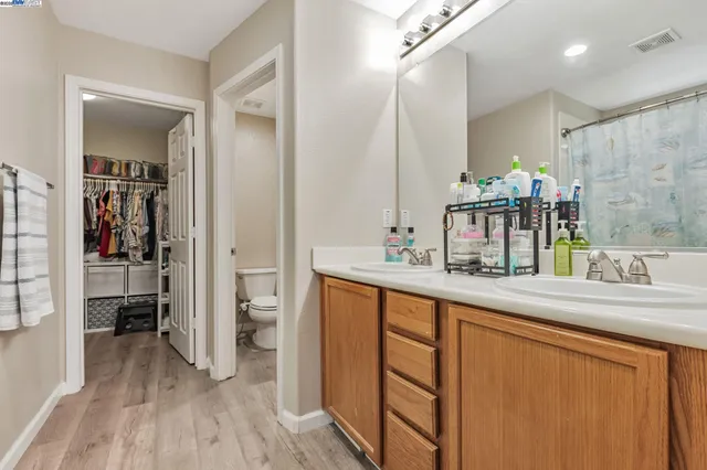 a bathroom with sink shower and mirror