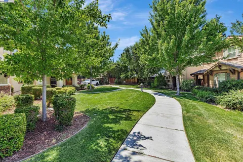 a view of house with outdoor space and garden