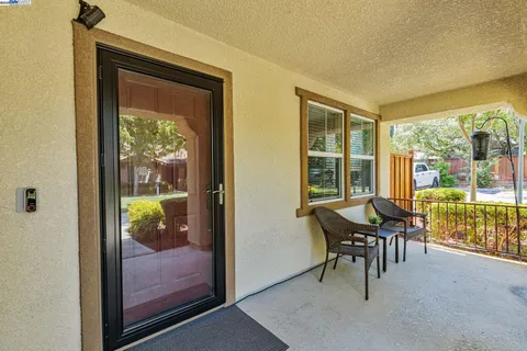 a dining room with furniture and a floor to ceiling window