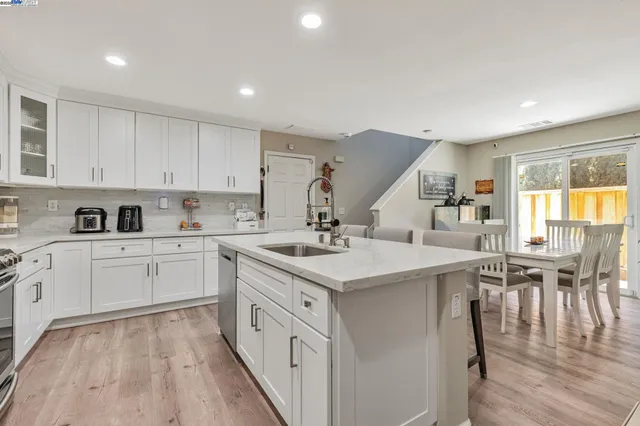 a kitchen with a sink stove and cabinets