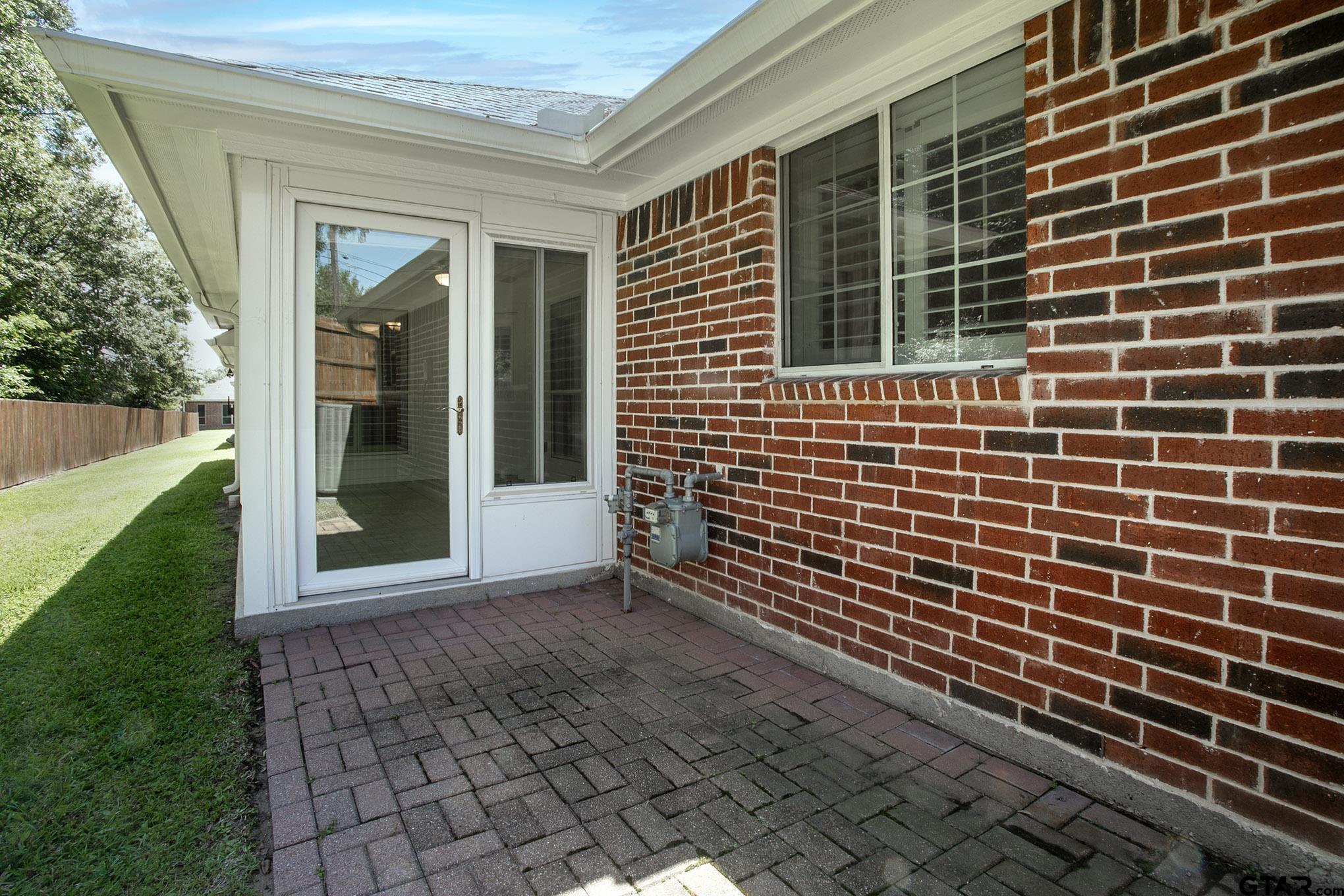 1521 Rice Road, Unit E105 Tyler, TX 75703 - Photo 28 of 32 a view of door with outdoor space