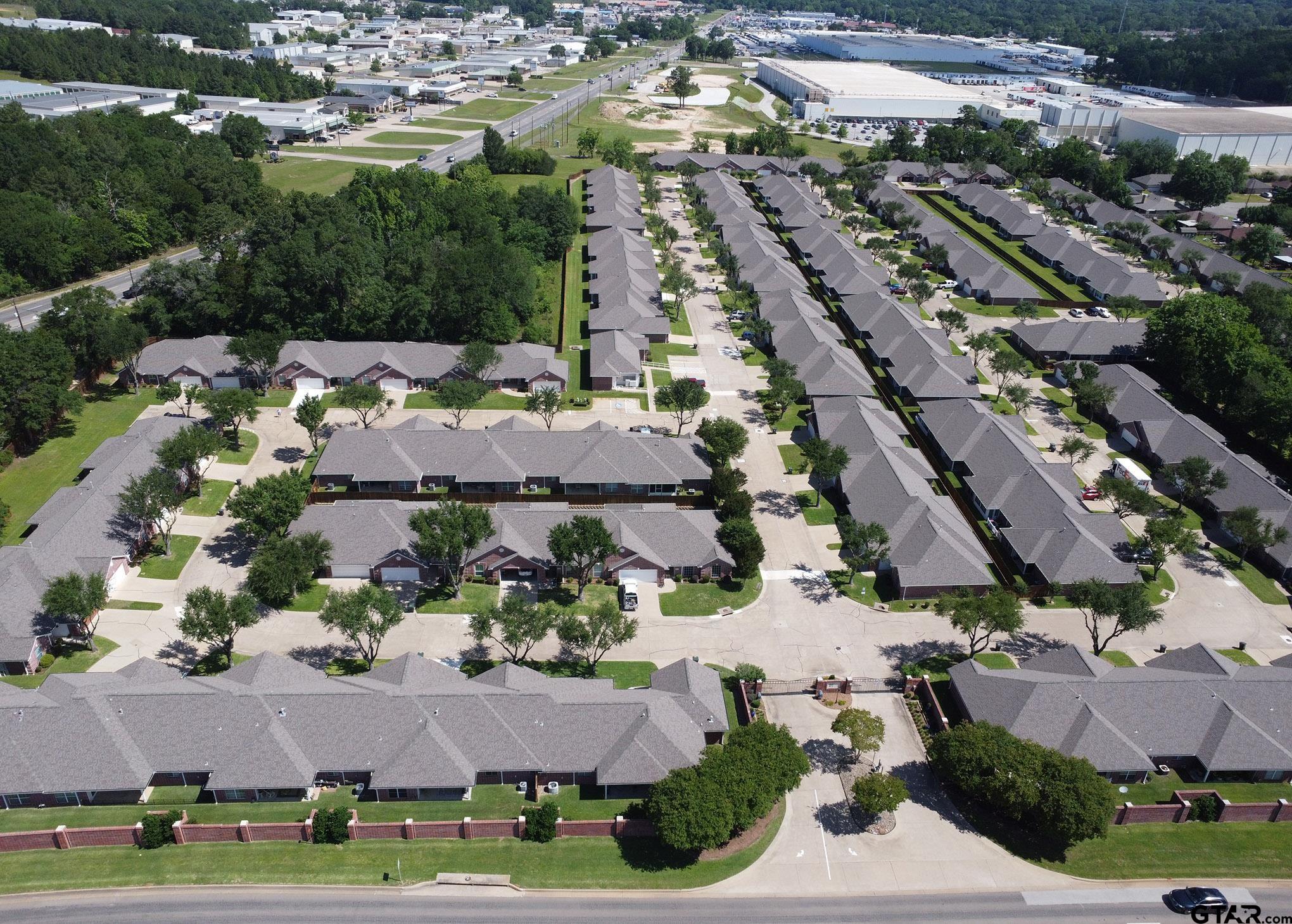 1521 Rice Road, Unit E105 Tyler, TX 75703 - Photo 29 of 32 an aerial view of residential houses with outdoor space
