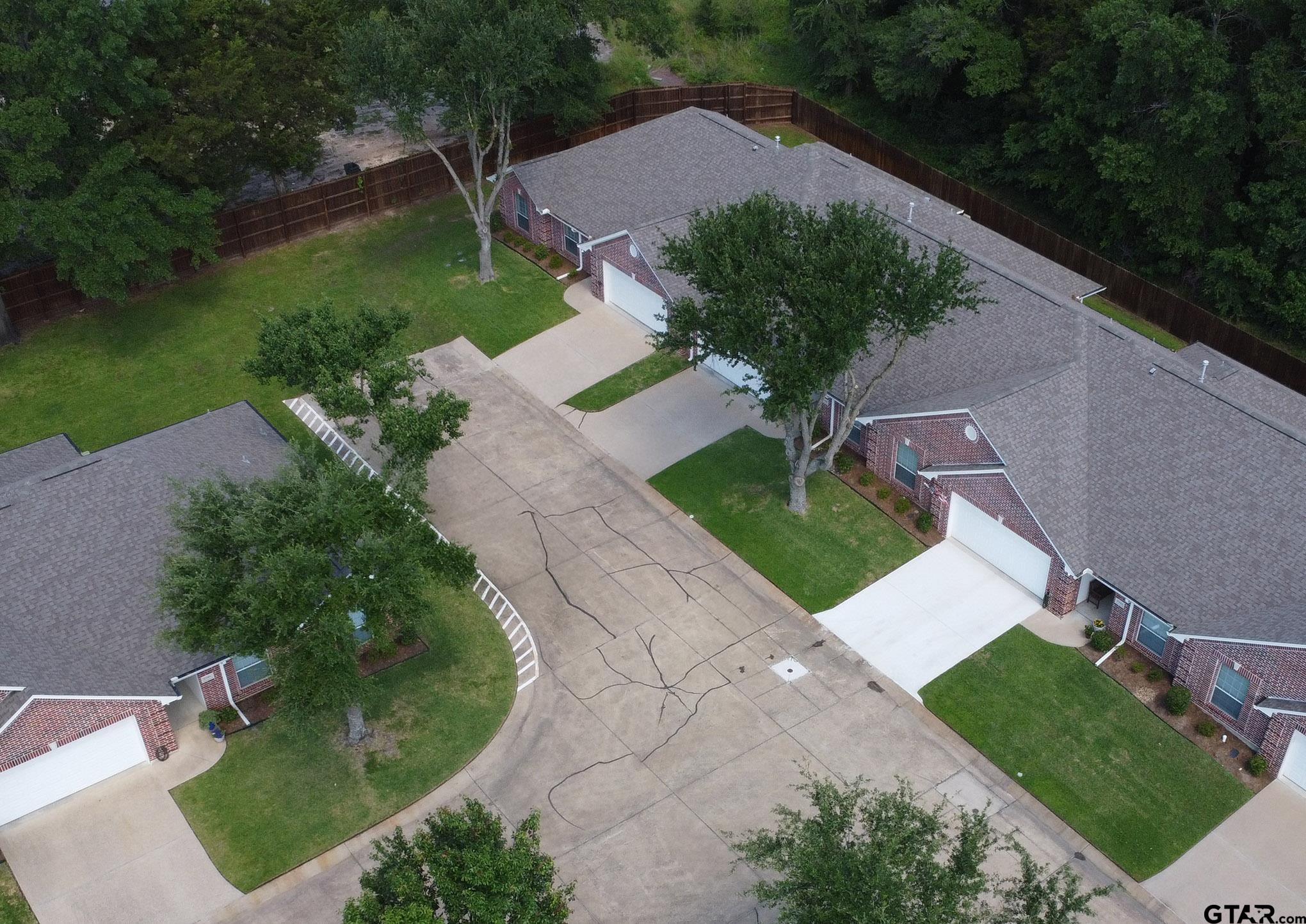 1521 Rice Road, Unit E105 Tyler, TX 75703 - Photo 31 of 32 a view of a garden with a house