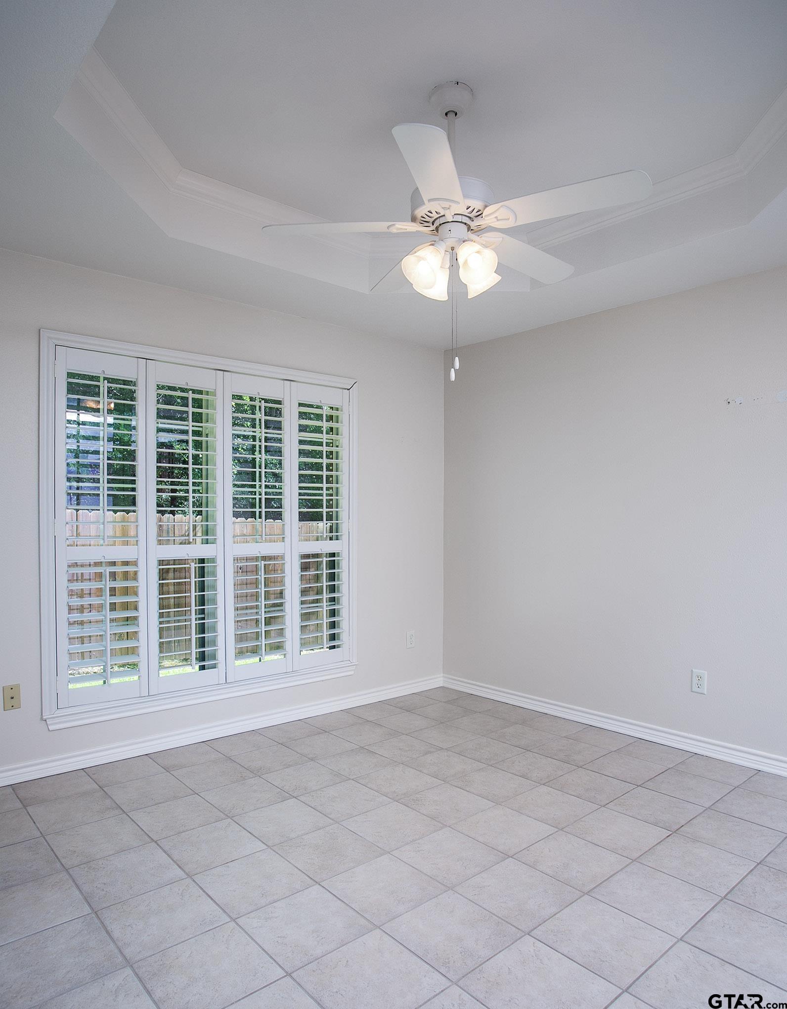 1521 Rice Road, Unit E105 Tyler, TX 75703 - Photo 9 of 32 a view of an empty room with a window