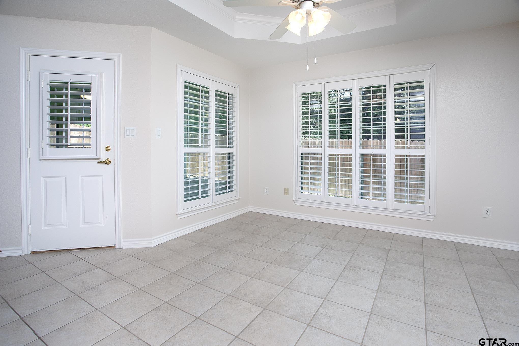 1521 Rice Road, Unit E105 Tyler, TX 75703 - Photo 10 of 32 a view of an empty room with a window