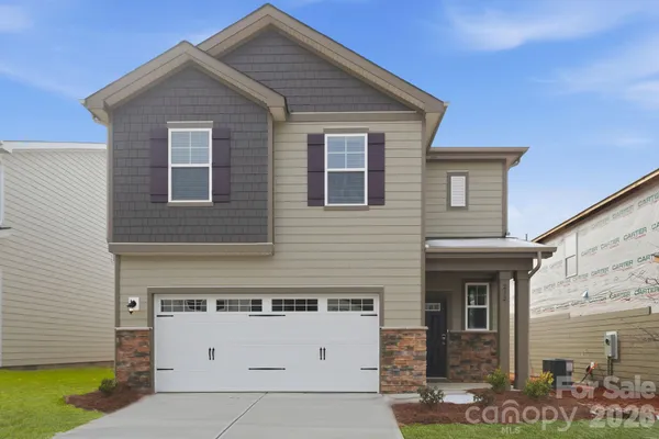 a front view of a house with garage