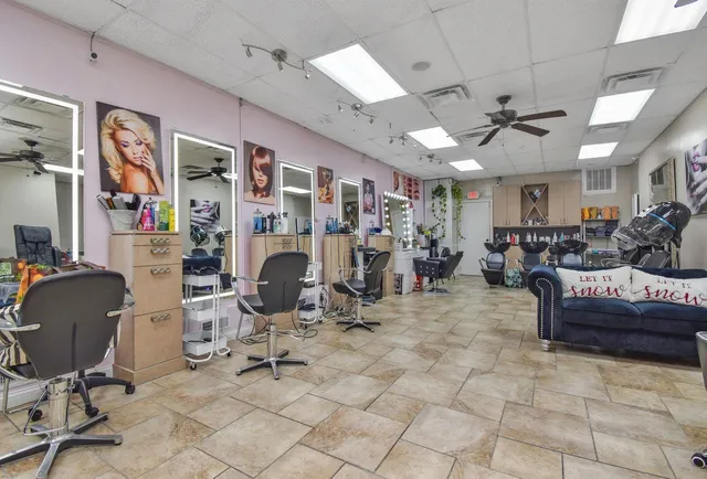 a view of a livingroom with furniture and a window