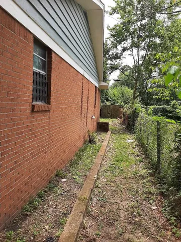 a pathway of a house with backyard