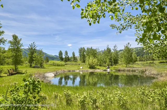 a view of a lake with houses in the back