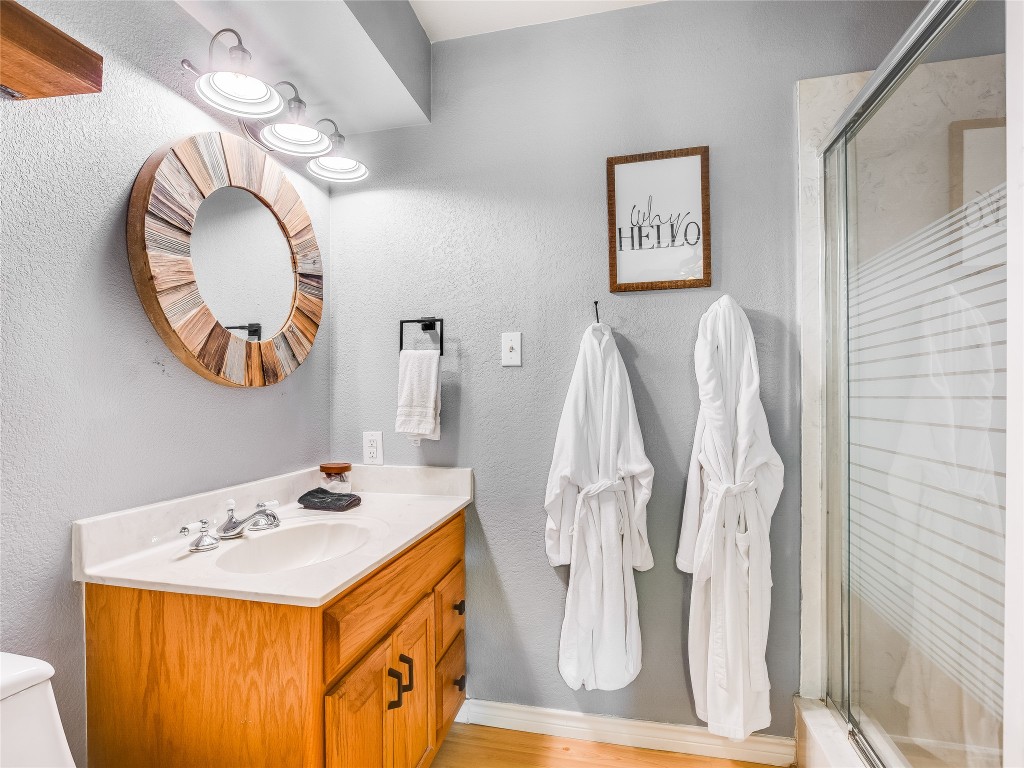 11000 Beach Road Leander, TX 78641 - Photo 14 of 38 a bathroom with a sink a mirror and a shower