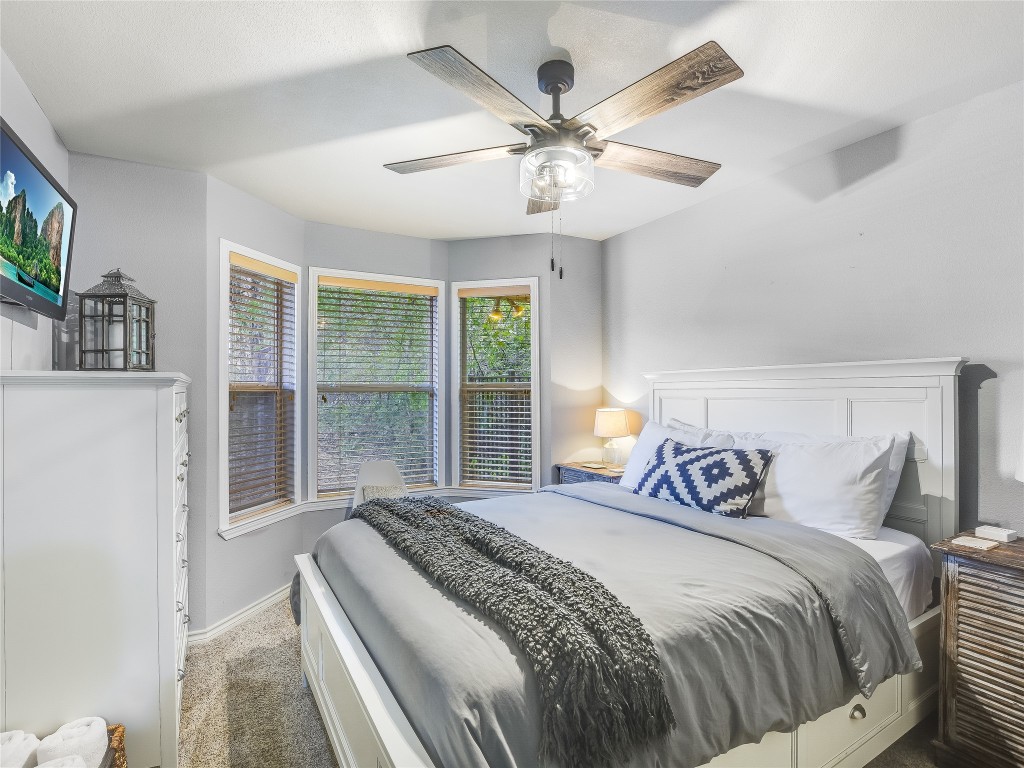 11000 Beach Road Leander, TX 78641 - Photo 15 of 38 a bedroom with a large bed and a large window