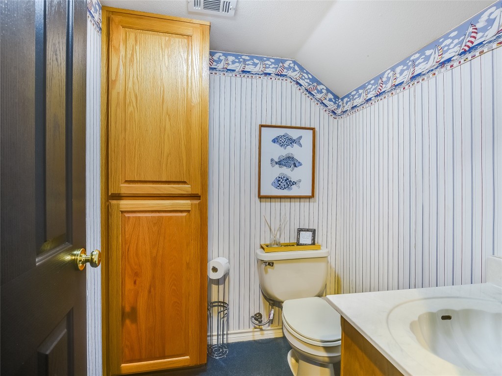 11000 Beach Road Leander, TX 78641 - Photo 20 of 38 a white toilet sitting next to a bathroom sink and tub