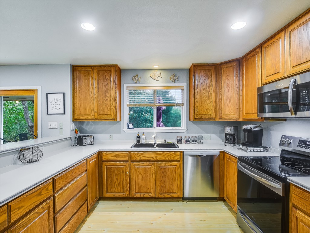 11000 Beach Road Leander, TX 78641 - Photo 10 of 38 a kitchen with a sink stove top oven and microwave