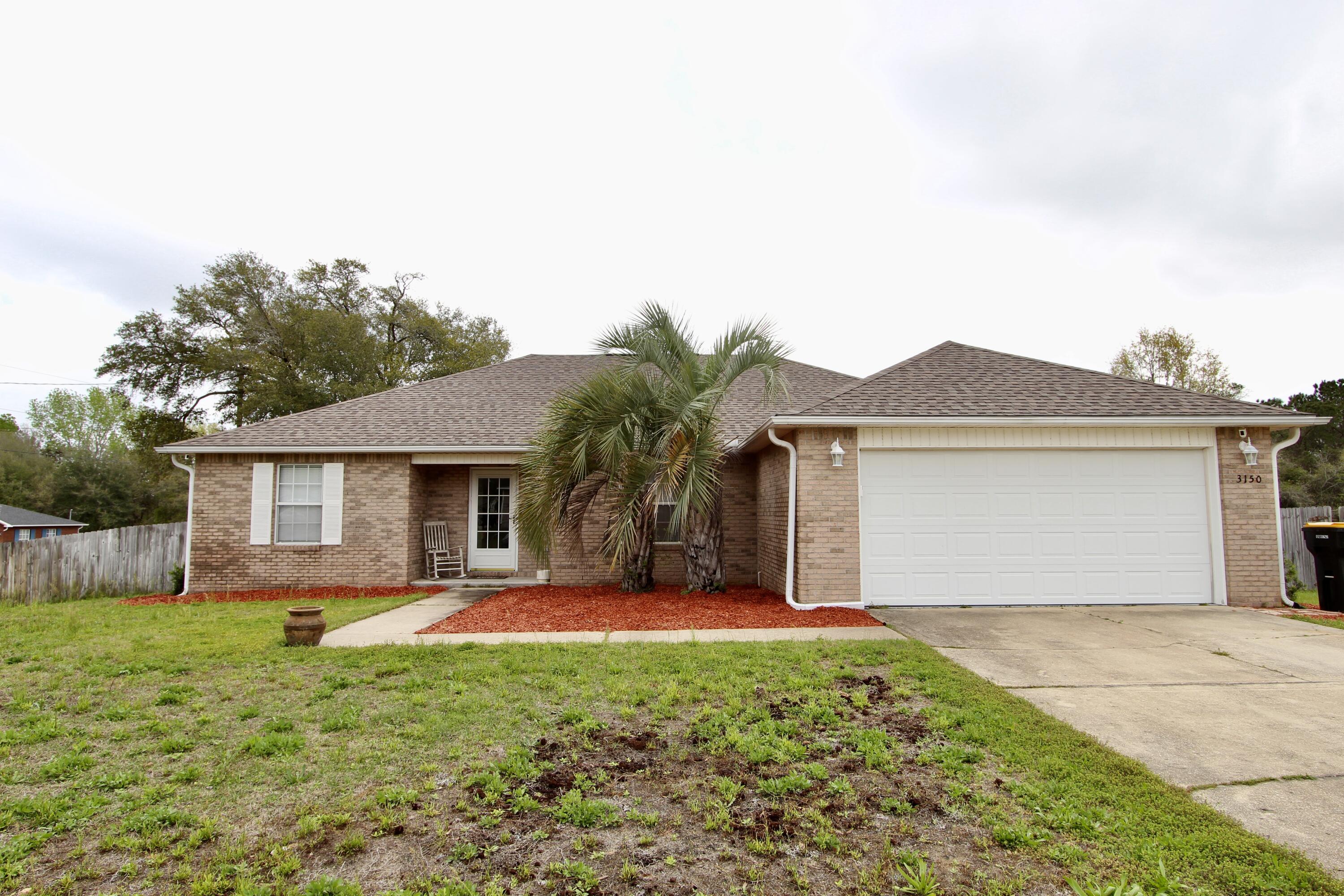 a front view of house with yard and garage