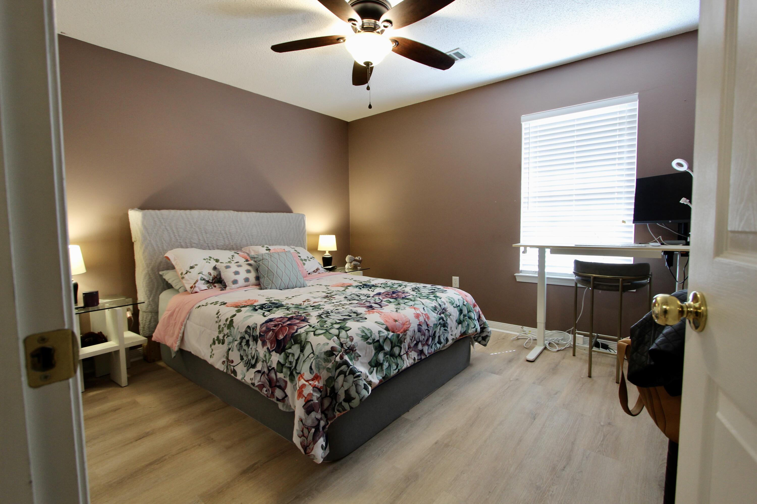 3150 Skyhawk Drive Crestview, FL 32539 - Photo 15 of 26 a bedroom with a bed and a chandelier