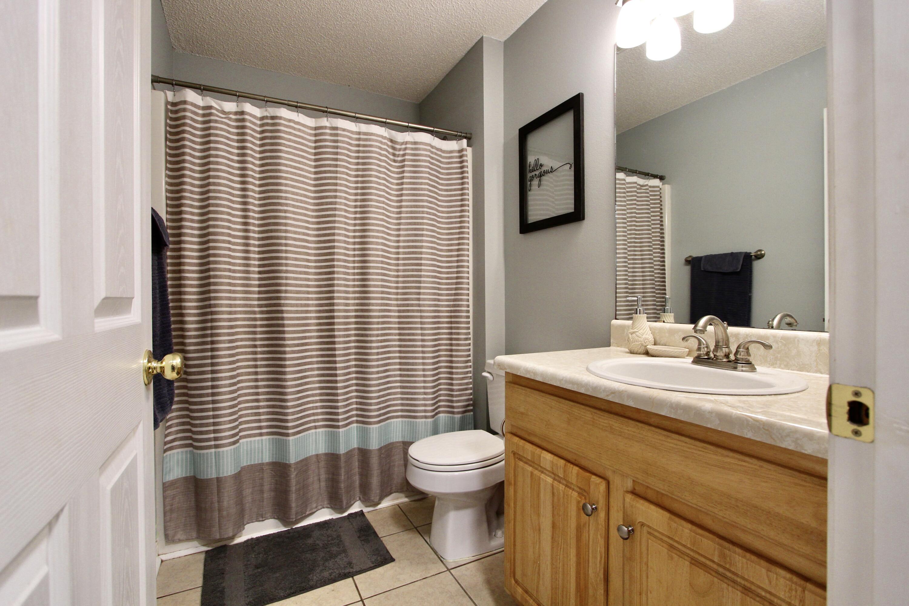 3150 Skyhawk Drive Crestview, FL 32539 - Photo 16 of 26 a bathroom with a sink a toilet and mirror