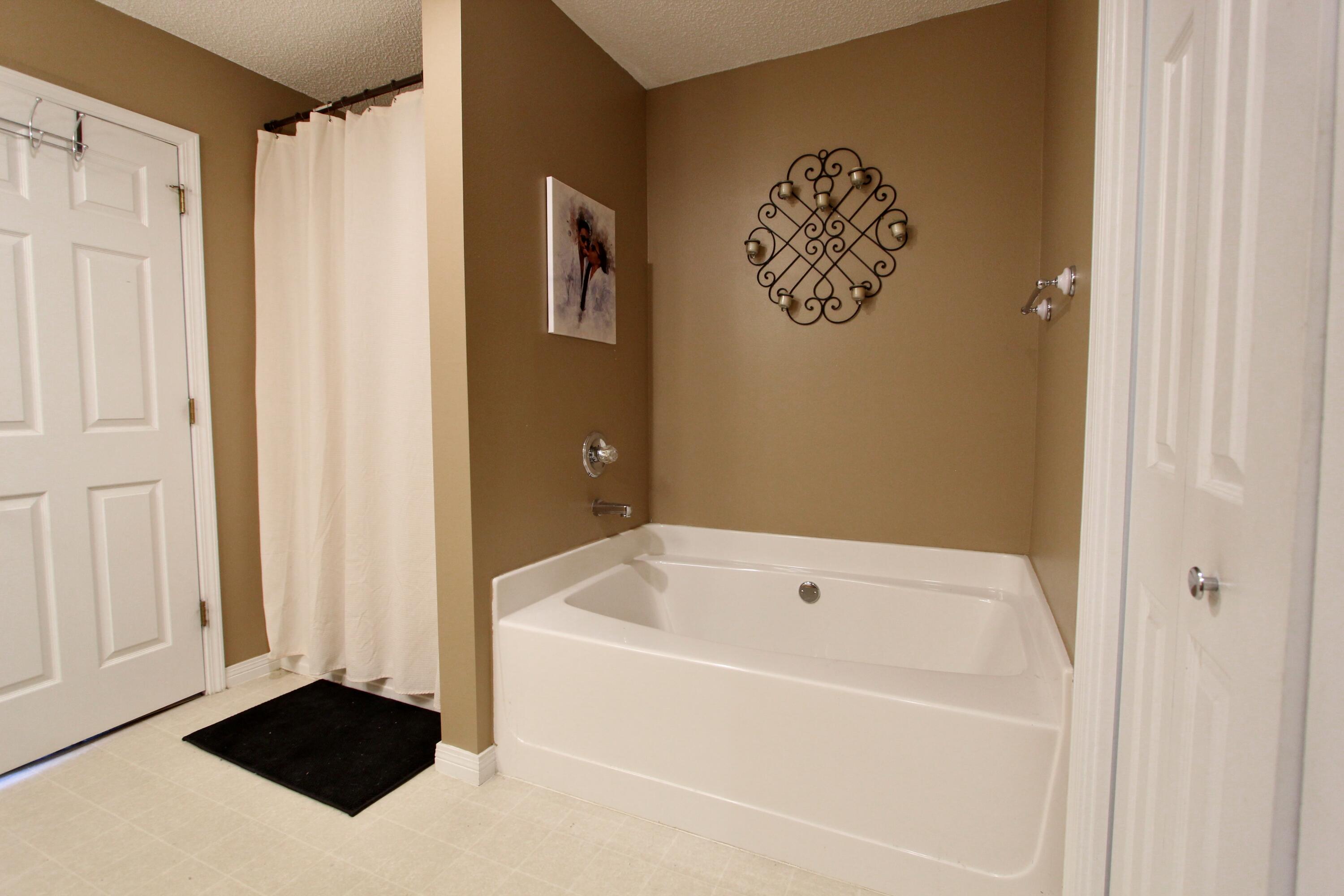 3150 Skyhawk Drive Crestview, FL 32539 - Photo 21 of 26 a bathroom with a bathtub and a shower