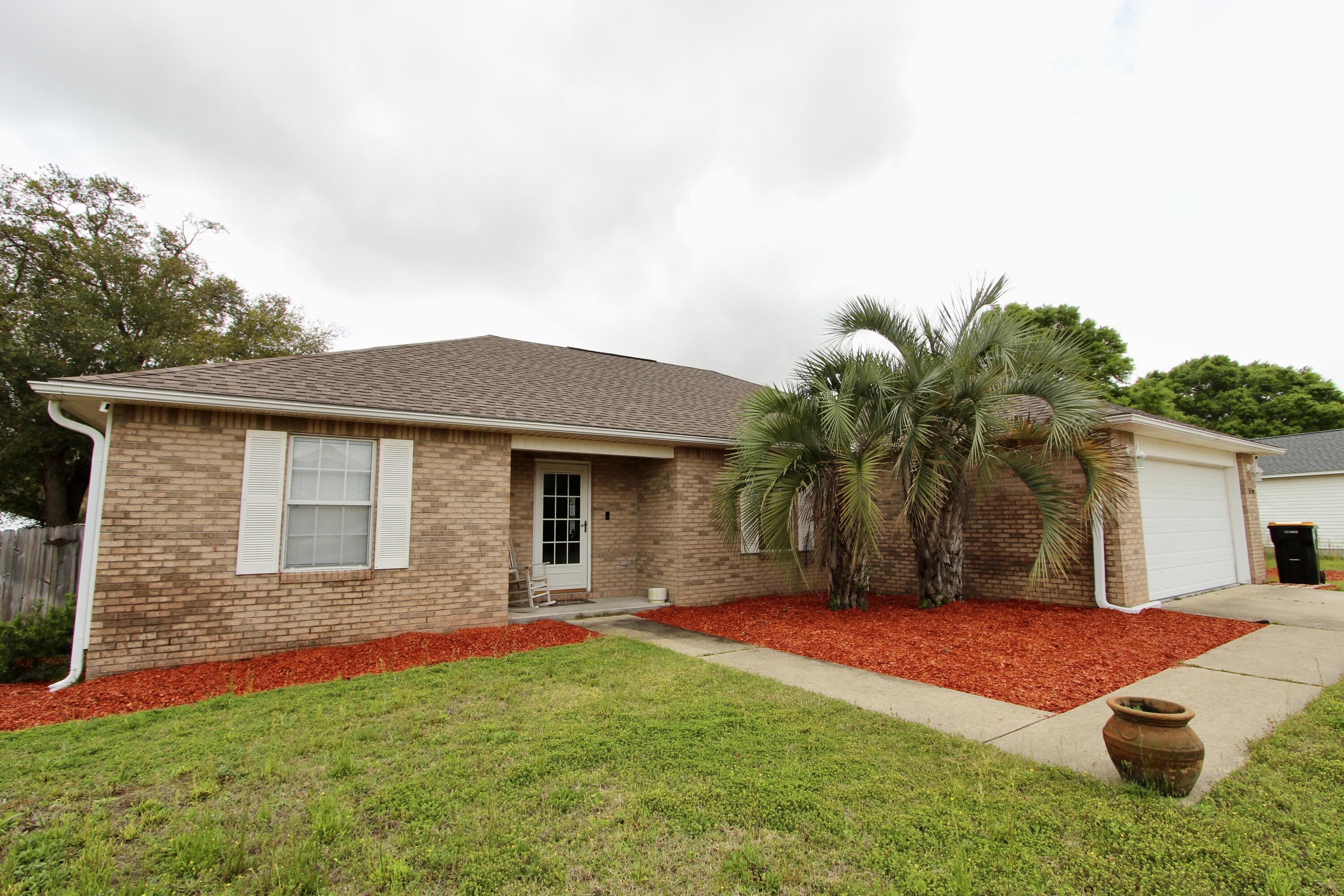 3150 Skyhawk Drive Crestview, FL 32539 - Photo 4 of 26 a front view of house with yard and palm tree