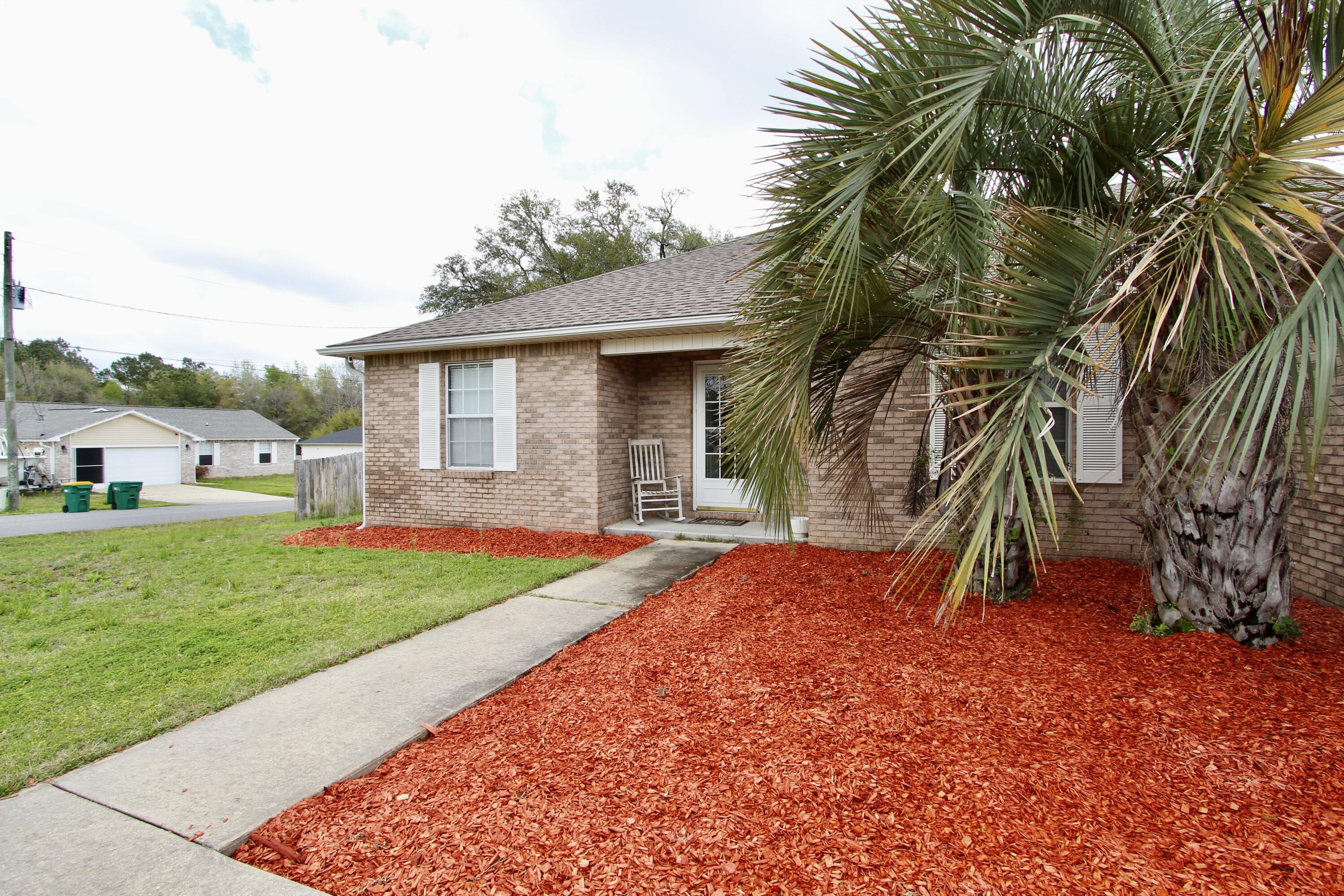 3150 Skyhawk Drive Crestview, FL 32539 - Photo 5 of 26 a view of backyard with seating space and trees