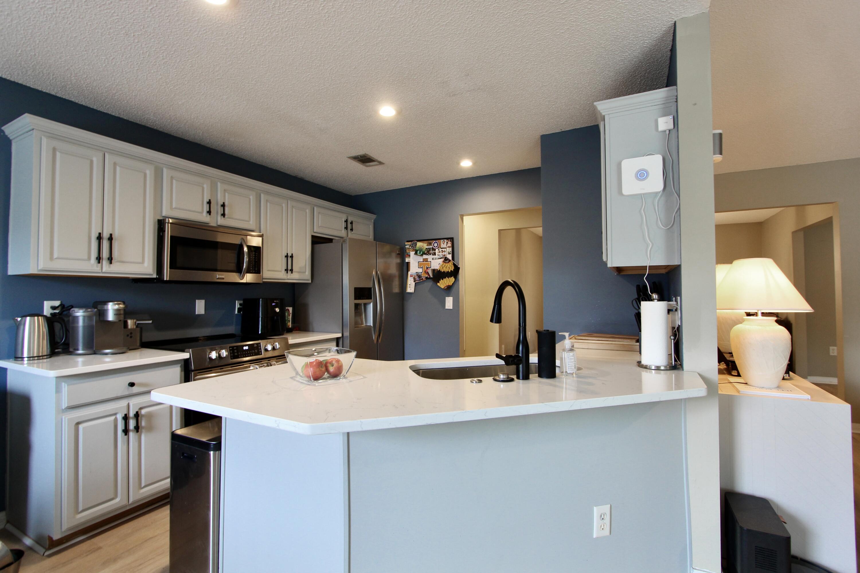 3150 Skyhawk Drive Crestview, FL 32539 - Photo 10 of 26 a kitchen with a sink a stove and microwave