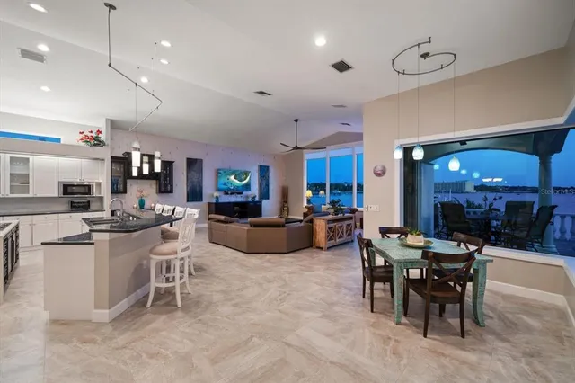 a living room with patio furniture and a floor to ceiling window