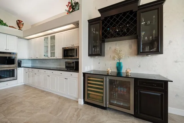 a view of a swimming pool with outdoor seating and yard in back