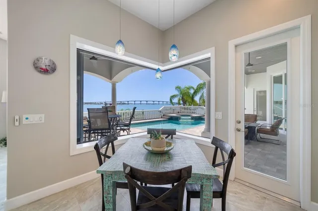 a balcony with wooden floor table and chairs