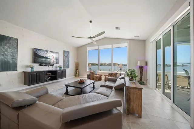 a view of a roof deck with couches and wooden floor