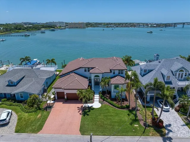 a aerial view of a house with outdoor space and lake view
