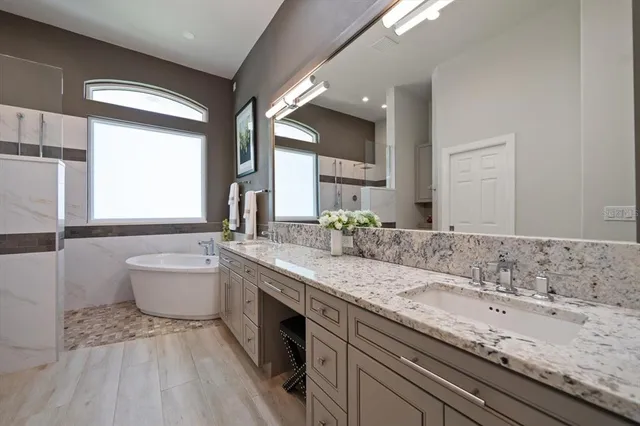 an aerial view of residential houses with outdoor space and swimming pool
