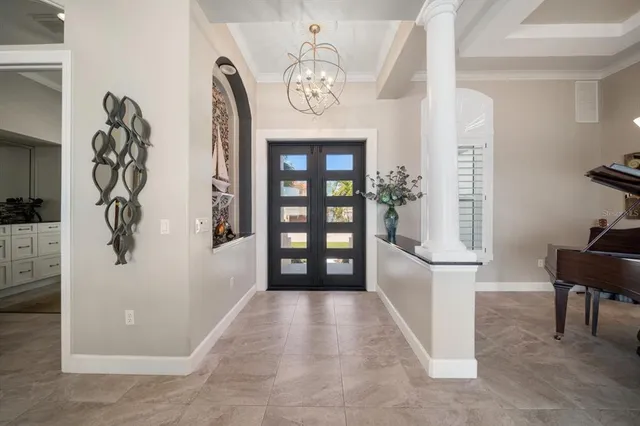 a kitchen with kitchen island granite countertop a sink cabinets and living room view