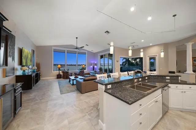 a view of a dining room with furniture and chandelier