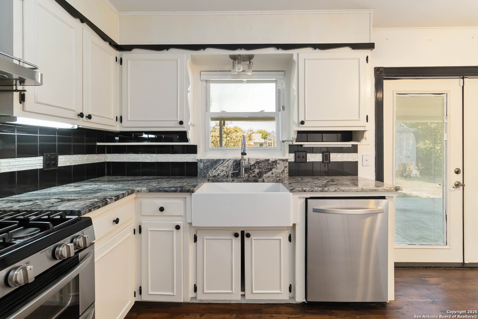 7903 Rimfire Drive San Antonio, TX 78227 - Photo 11 of 25 a kitchen with stainless steel appliances granite countertop a stove a sink and a white cabinets