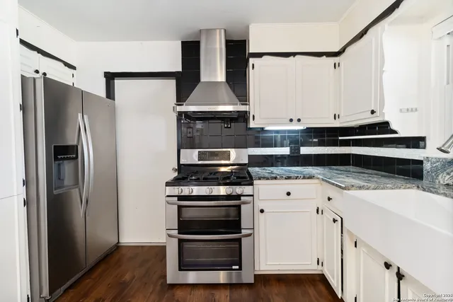 a kitchen with a stove and a refrigerator