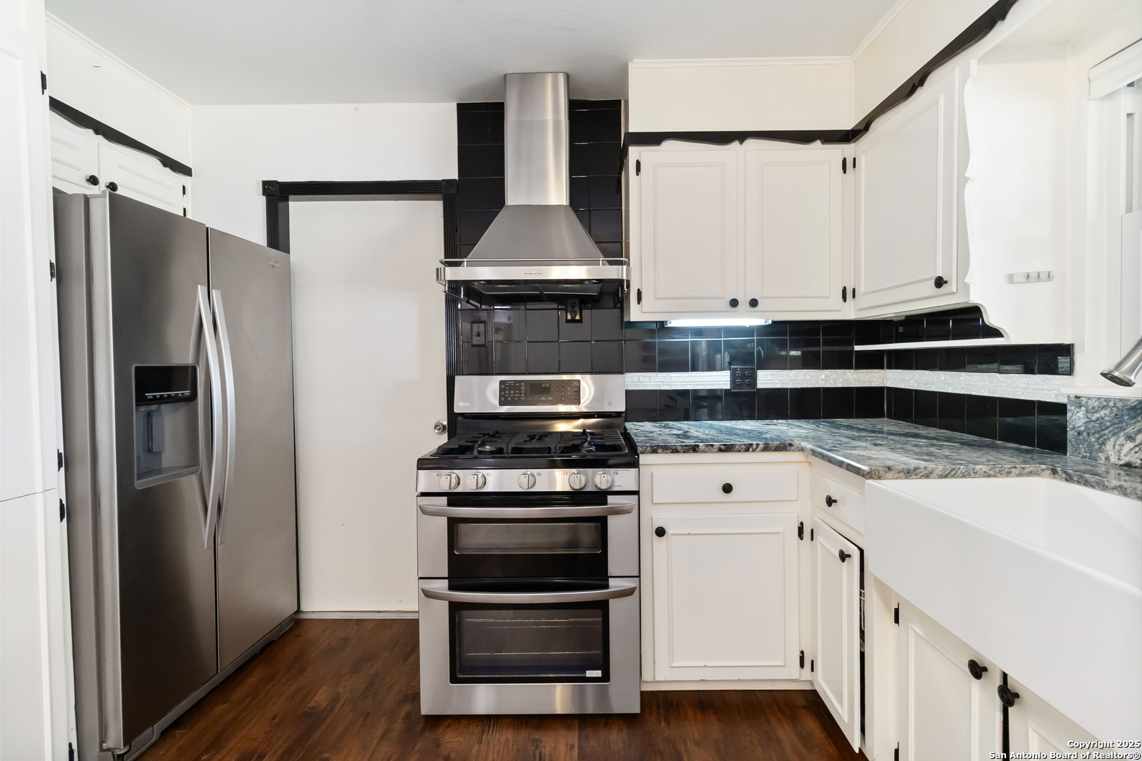 7903 Rimfire Drive San Antonio, TX 78227 - Photo 12 of 25 a kitchen with a stove and a refrigerator