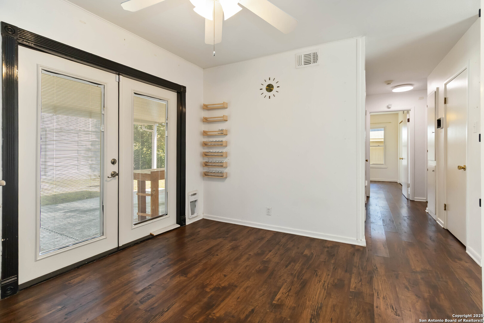 7903 Rimfire Drive San Antonio, TX 78227 - Photo 13 of 25 a view of a hallway with wooden floor and chandelier fan