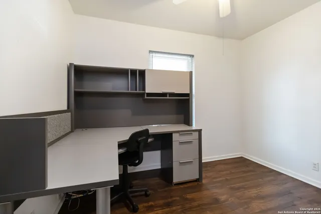 a room with a wooden floor and shelf