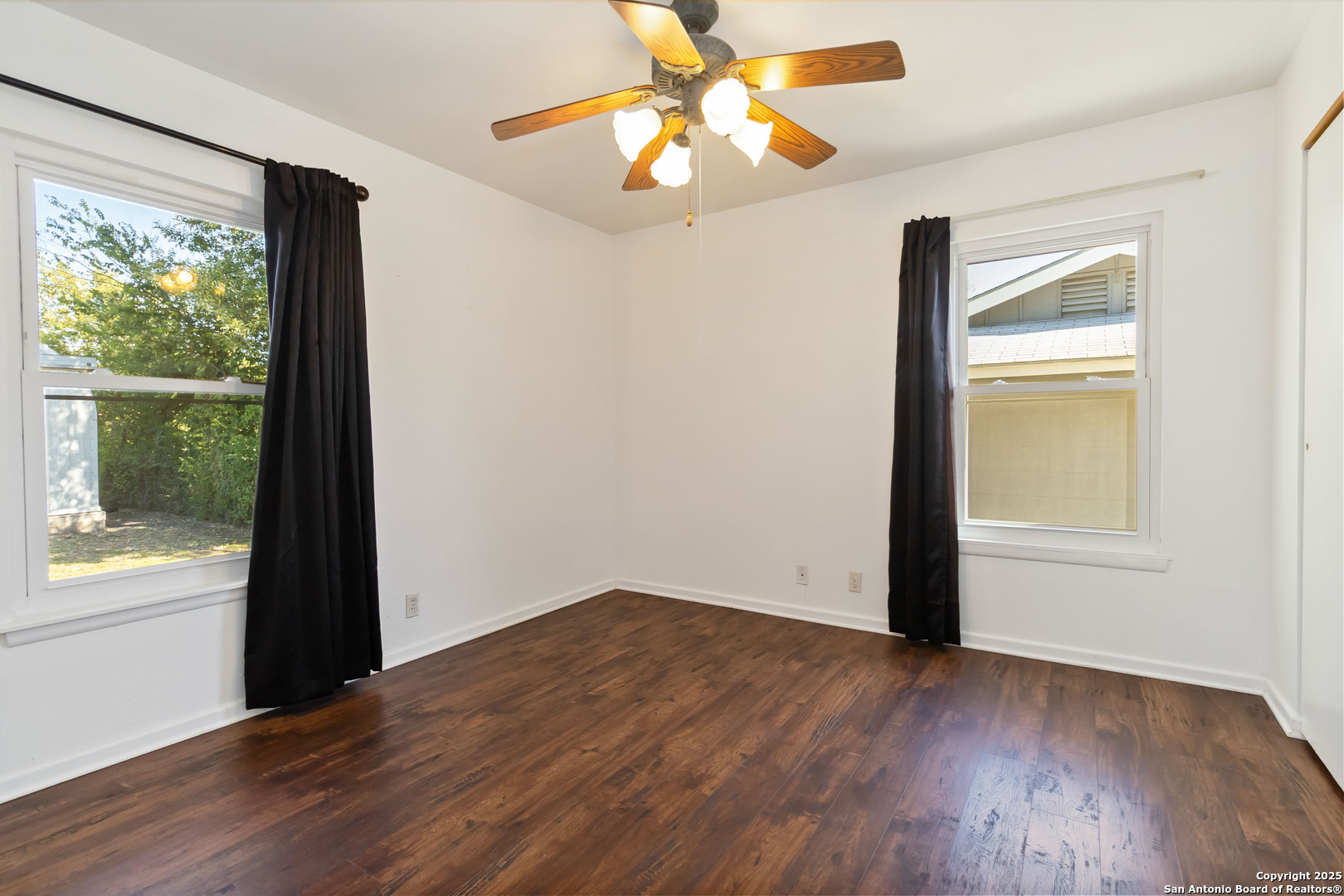 7903 Rimfire Drive San Antonio, TX 78227 - Photo 18 of 25 wooden floor in an empty room with a window