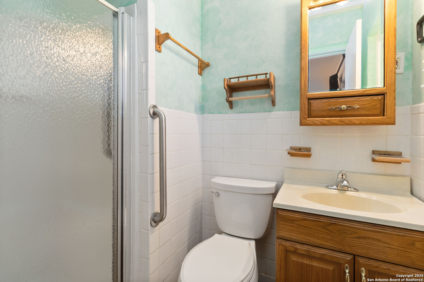 7903 Rimfire Drive San Antonio, TX 78227 - Photo 20 of 25 a bathroom with a toilet sink and mirror