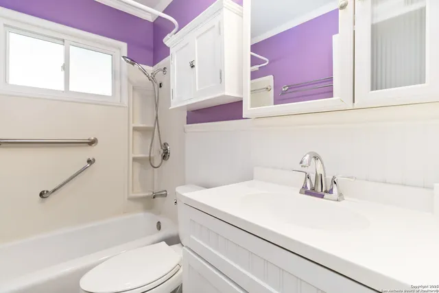 a bathroom with a sink toilet vanity granite tub and shower