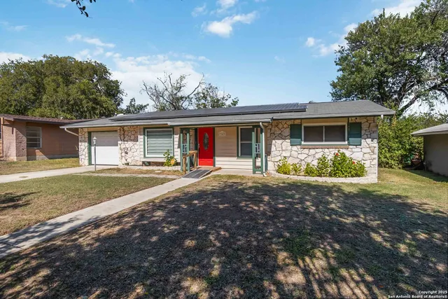 a front view of house with yard and green space
