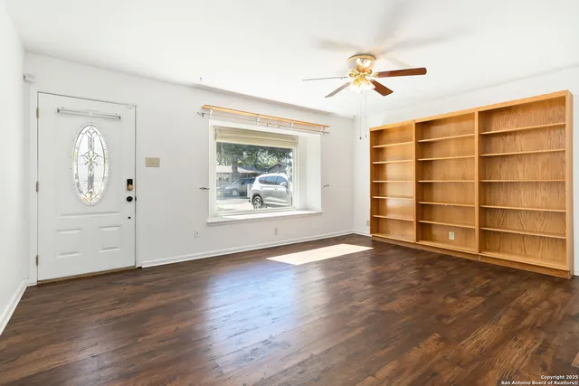 wooden floor in an empty room with a window
