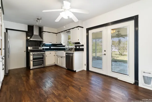 a kitchen with stainless steel appliances granite countertop a refrigerator and a stove top oven