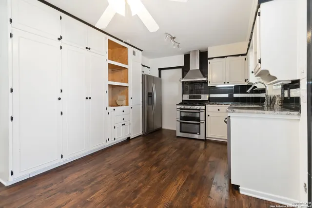a kitchen with stainless steel appliances a stove and a refrigerator