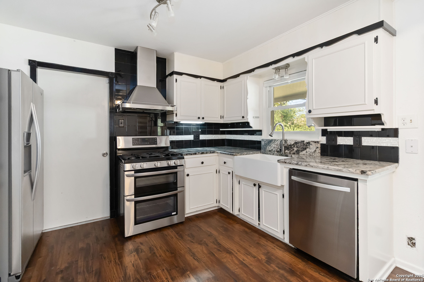 7903 Rimfire Drive San Antonio, TX 78227 - Photo 10 of 25 a kitchen with stainless steel appliances a stove a sink and a refrigerator