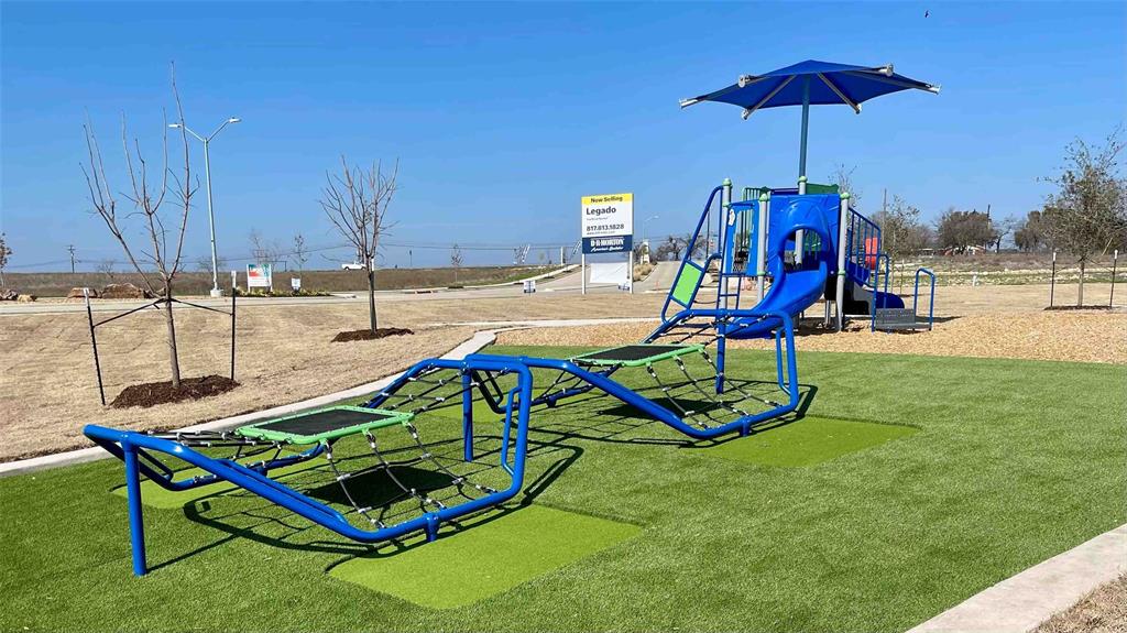 1922 Cherokee Lane Cleburne, TX 76033 - Photo 4 of 7 a view of a backyard with a slide and a slide